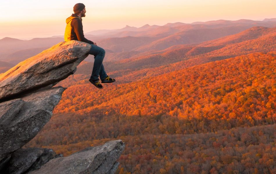 Man sitting on rock ledge